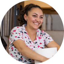 a female housekeeper smiling at camera